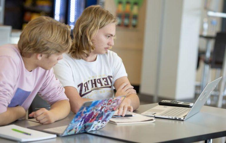 High school students working on lap top